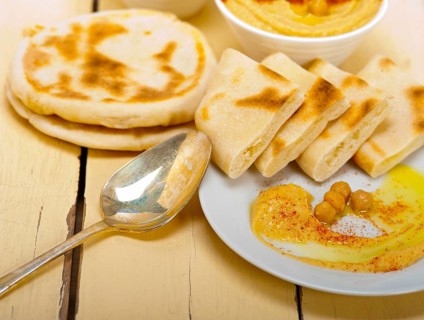 Traditional chickpeas Hummus with pita bread and paprika on top