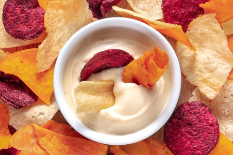 Vegetable chips with a dip close-up shot, top view