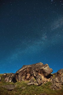 A large rock in the Caucasus against the Milky Way