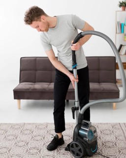 Male with vacuum cleaning