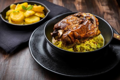 Roaster Pork Knuckle with savoy cabbage and baked potatoes - Traditional German cuisine, Eisbein,