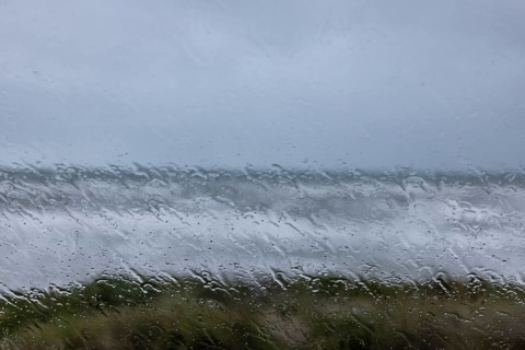 View of the stormy sea through raindrops on a window pane, Portbail, Cotentin, Manche, Normandy,