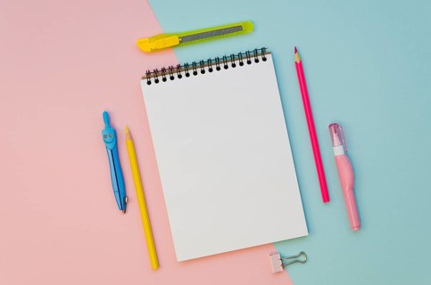 Top view notebook with colorful pens