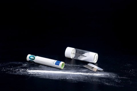 Cocaine Line and Razor Blade on a Black Background