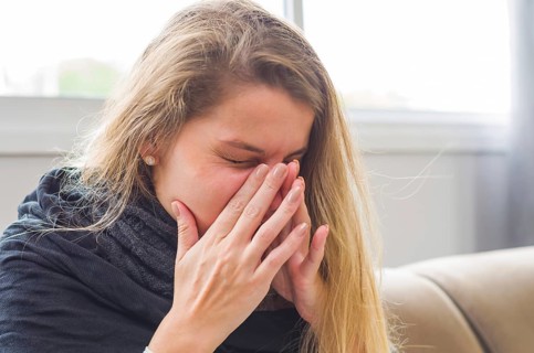 Great concept of allergy, rhinitis, cough. Young blonde woman coughing