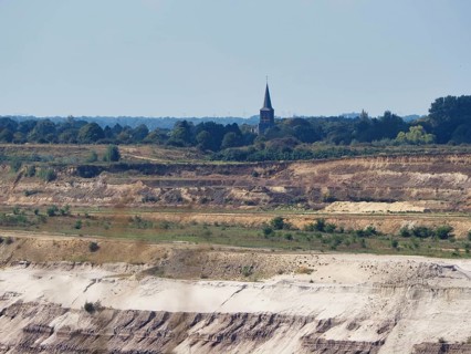 A church tower right on the edge of the Garzweiler open-cast lignite mine, Rhenish lignite mining