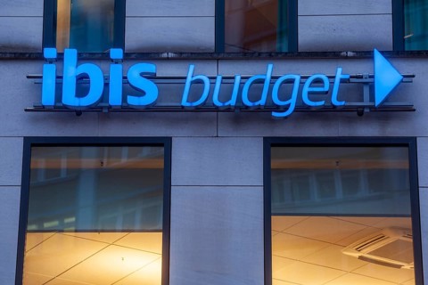 Ibis-Budget logo on an Ibis-Budget hotel at dusk, Bremen, Germany, Europe