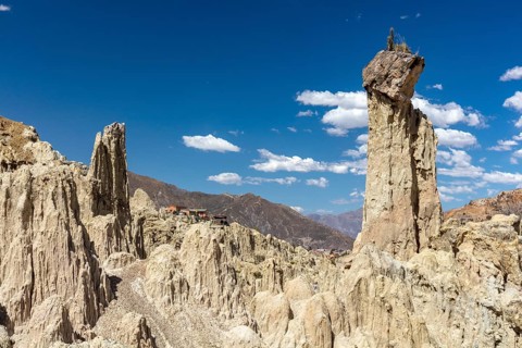 Earth pyramids with rocks on top, called Demoiselles Coiffées, precariously balanced rocks in Valle