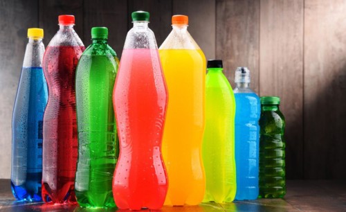 Plastic bottles of assorted carbonated soft drinks in variety of colors