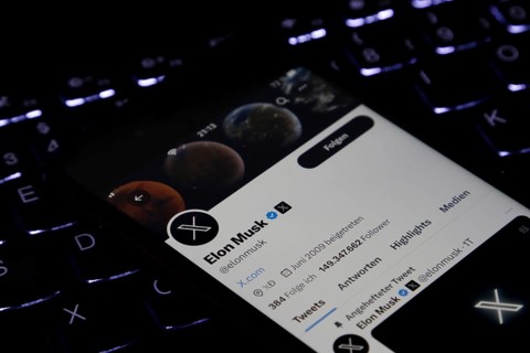 Symbolic image social media, close-up of a smartphone on illuminated computer keyboard with X logo