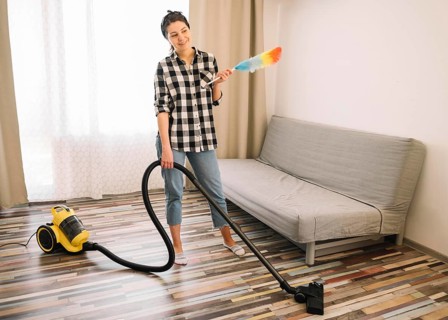 Woman vacuuming living room