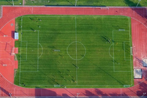 Aerial view at a soccer field with soccer players in Germany, Rhineland Palatinate near Bad