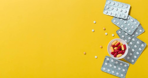 Flat lay pills with foils copy space