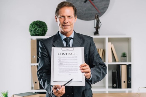 Mature lawyer pointing signature place contract document with pen