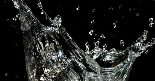 Water Exploding and Splashing against Black Background
