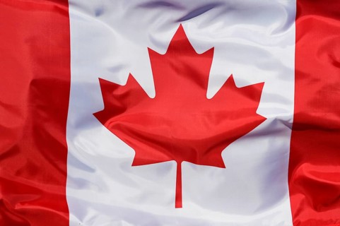 Close-up of the national flag of Canada, fluttering in the wind with folds, wave pattern