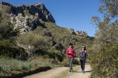Two hikers walking along the Assarell path, Pollença, Mallorca, Balearic Islands, Spain, Europe
