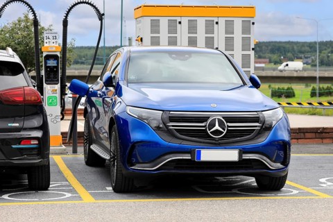 Blue Mercedes-Benz EQC 4-matic electric SUV car charging battery at public charging point. Salo,