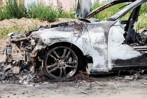 Road wreck accident or arson fire burnt wheel car vehicle junk