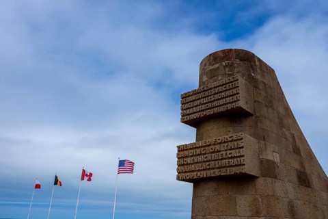 Walking the sands of Omaha Beach, the echoes of D-Day's fierce battle linger in the air. Waves