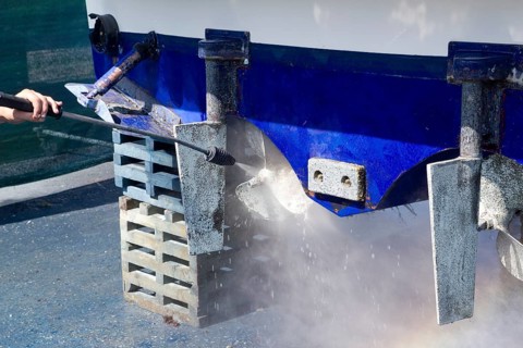 Pressure washer cleaning boat hull barnacles antifouling and seaweed