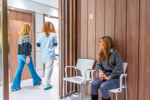 Nurse taking a patient from the waiting room because it was their visiting time