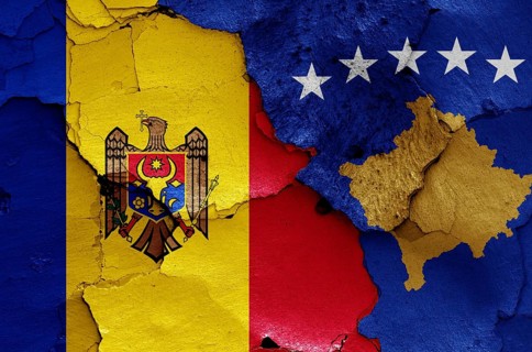 Flags of Moldova and Kosovo painted on cracked wall