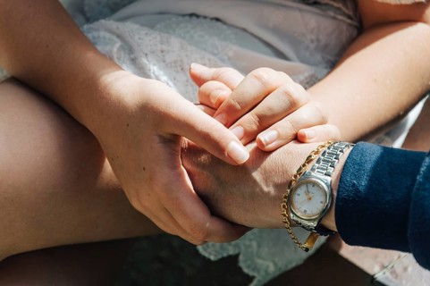 Hands of mother and daughter holding together showing love and gratefulness