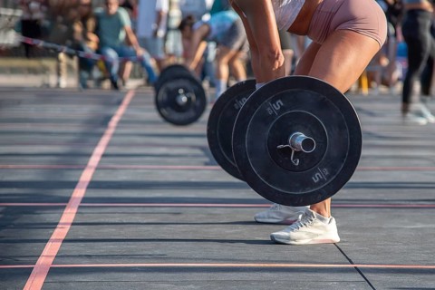 Part of a photo of an intense moment as the athlete prepares to lift the heavy barbell at an