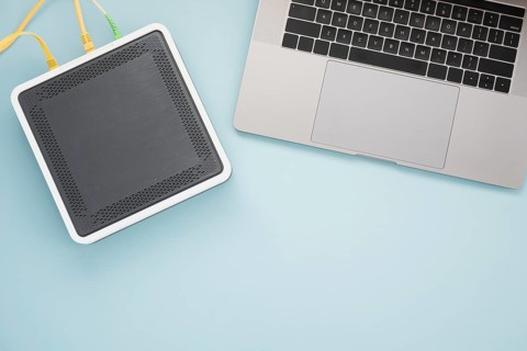 Flat lay desk with laptop wireless router