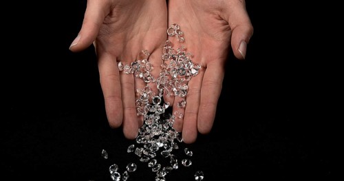 Hand of Woman with Diamonds against Black Background