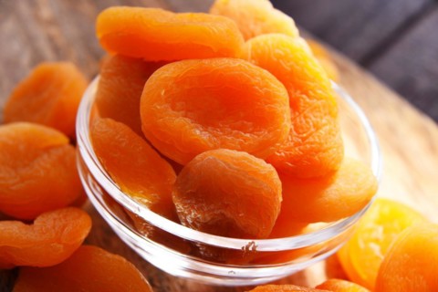 Composition with a bowl of dried apricots. Delicacies