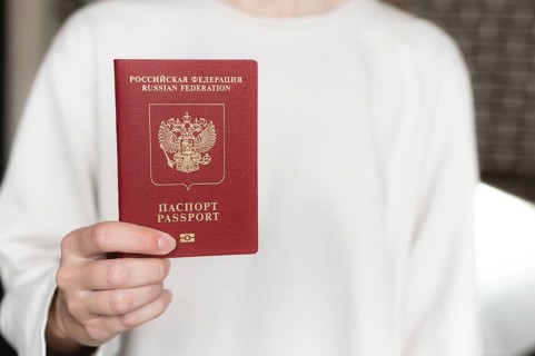 Foreign passport of the Russian Federation. Human female hand with a Russian passport close-up on