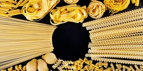 Italian pasta panoramic design with copyspace, a flatlay of an assortment of pasta types, shot from