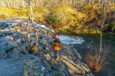 Hiker admiring zaldibartxo waterfall in gorbeia natural park, basque country, a beautiful nature