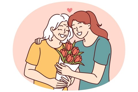 Woman hugs elderly mother and gives bouquet of flowers congratulating with birthday or mother day
