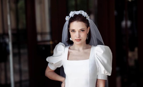 Beautiful young woman bride happy on her wedding day in a white dress and veil