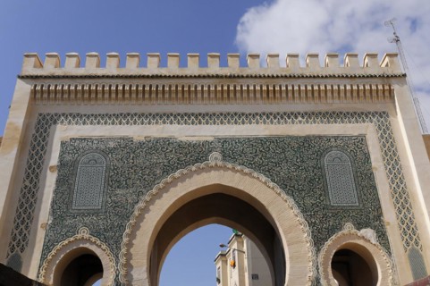 Royal Palace Dar el-Makhzen, Fes, Oriental arch with green and white mosaics under a blue sky,