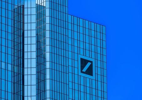 Twin towers of the Deutsche Bank headquarters with the company logo slash in the square, Frankfurt