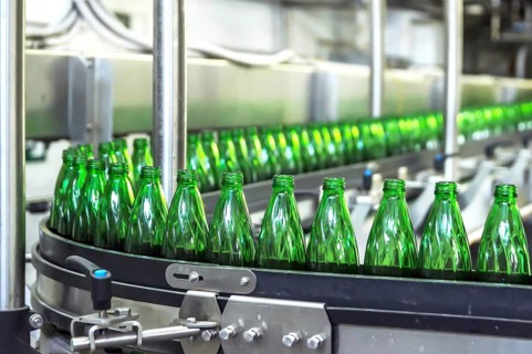 Closeup on mineral water green bottles in raw and lines
