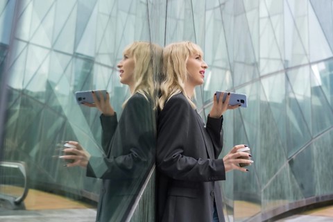 Entrepreneurial girl business park in a modern building reflected in the windows, young blonde in a