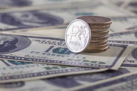 New russian ruble coin and american dollars. Closeup