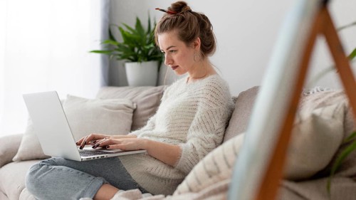 Side view woman writing blog home