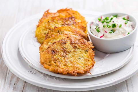 Fried potato pancake with radishes cream cheese and chives. Vegetarian food concept