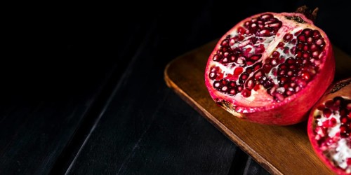 High angle autumn pomegranate halves with copy space