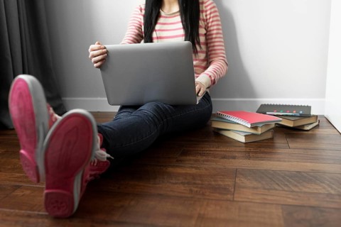 Close up student holding laptop