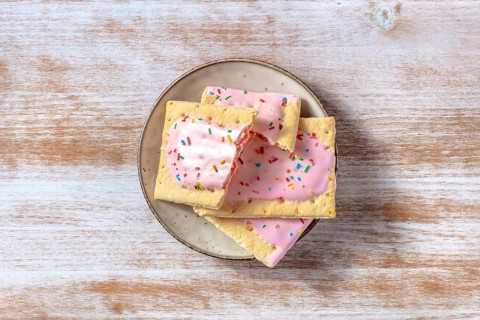 Strawberry pop tarts, shot from the top on a plate on a rustic wooden background
