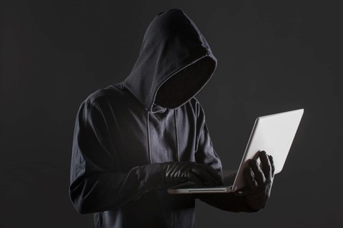 Side view of male hacker with gloves and laptop. Resolution and high quality beautiful photo