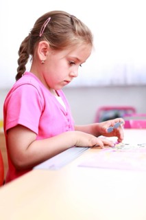 Cute child playing with puzzle