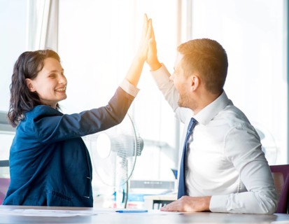 Two businesswoman businessman giving hi five office